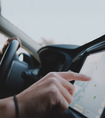 Woman using touchscreen in car